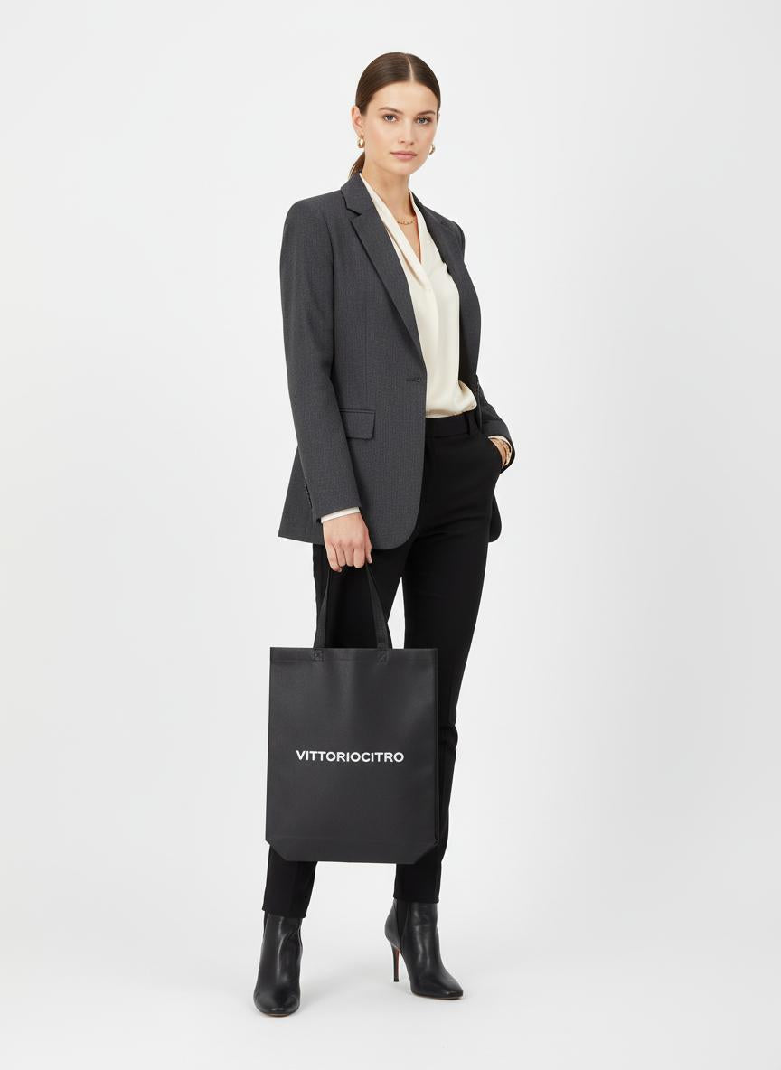 Donna elegante con shopper TNT nero personalizzata VITTORIOCITRO, perfetta per look professionali e praticità quotidiana.